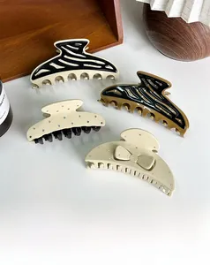 Collection of oversized acetate hair claws featuring rhinestone and zebra patterns