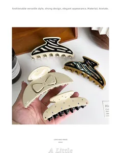 Detailed view of large acetate claw clips with rhinestones and elegant tortoise patterns