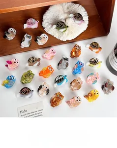 Close-up of cute owl and turtle cellulose acetate hair claws with marble and tortoiseshell patterns
