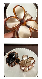 Detail view of flower hair claw clip with amber frame and matte champagne petals