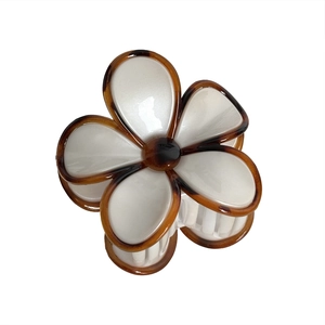 Elegant frangipani flower hair claw clip with white petals and brown tortoiseshell edges