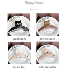 Detail of cute bear and dog shark hair clips with crystals on a white ceramic plate