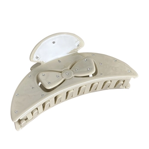 Elegant beige acetate shark clip with bow design and sparkling rhinestones for women