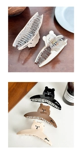 Detail of cute bear-shaped hair claws in beige, brown and black with Grace engraving