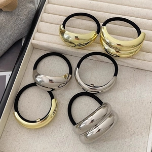 Retro metallic elastic hair ties in gold and silver finish with textured oval ornaments