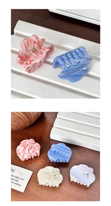 Detail of cloud-shaped acetate hair clips with inlaid rhinestones and marble texture