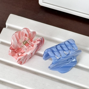 Cloud shaped acetate hair claws with marble texture and sparkling rhinestone accents