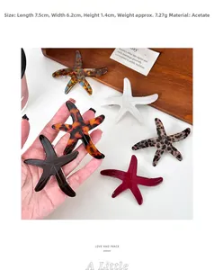 Starfish shaped acetate hair clips shown in tortoise and marble patterns on wooden tray