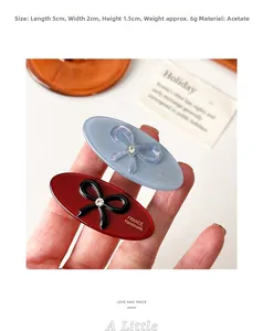 Detail of oval acetate hair clip with rhinestone bow showing 5cm length measurement