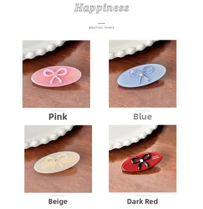 Detail of acetate oval hair clips with rhinestone bows in pink, blue, beige and red