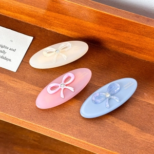 Elegant oval acetate hair clips with bow rhinestones in cream, purple, and blue colors