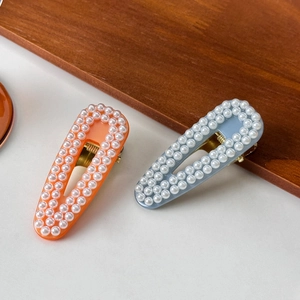 Elegant teardrop pearl hair clips in orange and light blue for women's hair styling