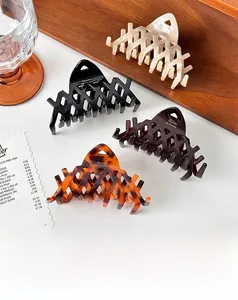 Close-up of French vintage acetate claw clips in ivory, black, coffee, and tortoise shell