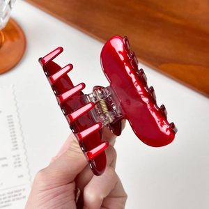 Glossy bright red acetate bow hair claw clip with golden metal spring for women