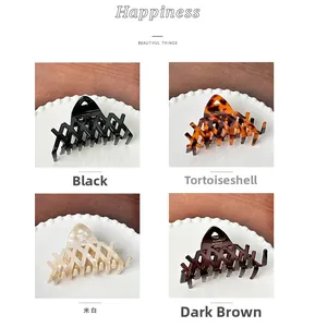 French vintage acetate hair claws in four colors with hollow design and gold logo