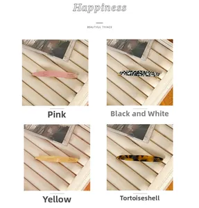 Detail view of acetate barrettes in pink, black-white, yellow and tortoiseshell colors