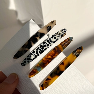 Set of 4 elegant acetate hair clips featuring tortoise shell and marble patterns