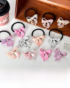 Flat lay of acetate bow hair clips and scrunchies set with elegant marble texture