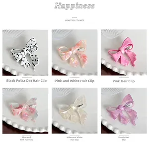 Close-up of acetate bow hair clips in various patterns with metal spring clips
