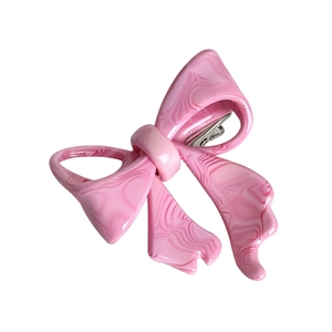 Pink marble texture acetate bow hair clip with silver metal duckbill grip on white background
