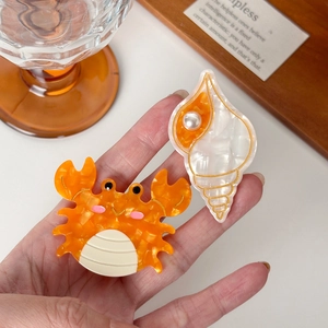 Handheld ocean series acetate duckbill clips featuring orange crab and white shell with pearls
