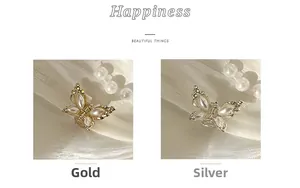 Detailansicht der goldenen und silbernen Schmetterlings-Haarklammern mit Perlen und Strass
