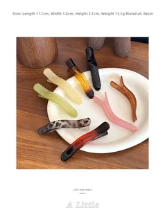 Detailed resin hair clip dimensions showing 11.1cm length on a minimalist tray