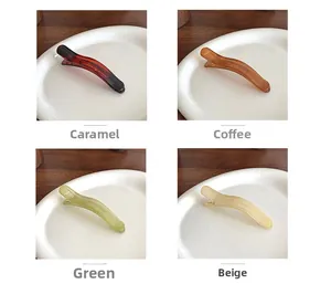 Close-up of translucent jelly duckbill hair clips in four elegant assorted colors