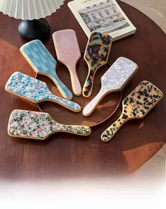 Detail of luxury acetate air cushion brushes in tortoiseshell and marble patterns
