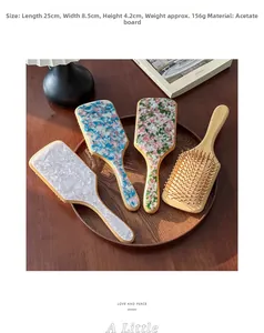 Detailed close-up of large acetate and wood massage hairbrushes in a rustic wooden tray