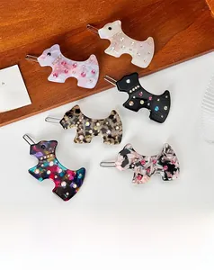 Detail of six dog-shaped acetic acid hair clips with rhinestone accents and metal backs
