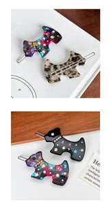 Detail of dog-shaped acetate hair clips with sparkling rhinestones and floral patterns