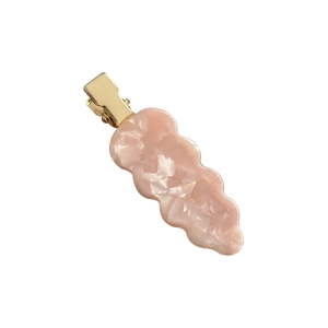 Pink marble pattern acetate hair clip with wavy edges and gold metal duckbill clamp