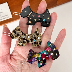 Three acetate Scottie dog hair clips with rhinestones in black, leopard, and floral patterns