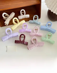 Detailed view of colorful acetate claw clips with marble textures and bow designs