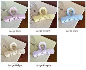 Detailed view of matte large bow claw clips in various macaron colors on textured background
