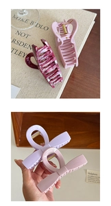 Detailed macro view of large pastel acetate hair claws and marble texture shark clips