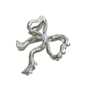 Silver liquid metal butterfly hair claw clip with pearl accent on a white background