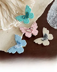 Detailed view of acetate butterfly hair clips set with rhinestones and heart love motif