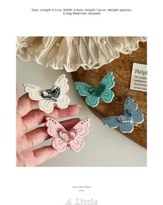Close-up of pastel acetate butterfly hair clips in cream, pink, green and blue colors
