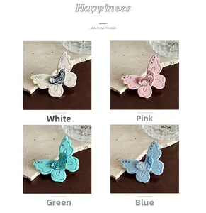 Detailed close-up of acetate butterfly hair clips with heart engraving in four pastel colors