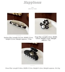 Detailed size view of black acetate hair claws with elegant pearl reindeer motifs