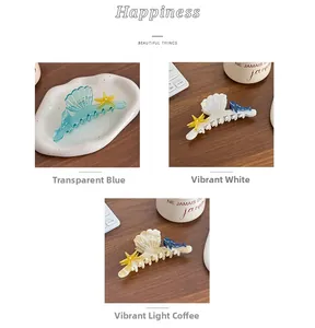Close-up of ocean-themed acetate hair claws with starfish and whale charms in three colors