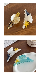 Detailed close-up of ocean-themed acetate hair claws featuring shell and dolphin designs