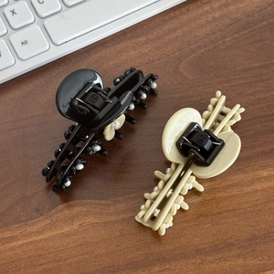 Elegant acetate flower hair claw clip with pearl accents in black and beige finishes