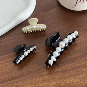 Elegant French pearl hair claw clips in black and cream for sophisticated hairstyles