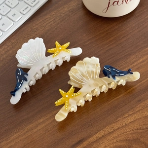 Ocean series acetate hair claws with starfish and whale motifs in pearl and amber finish