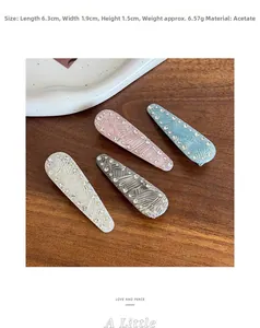 Detail view of four marble texture acetate hair clips with subtle rhinestone embellishments