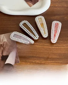 Detailed view of acetate hair clips with pearl edges in various geometric patterns