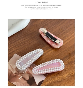 Close-up of pearl-embedded hair clips with pink marble and gradient acetate textures